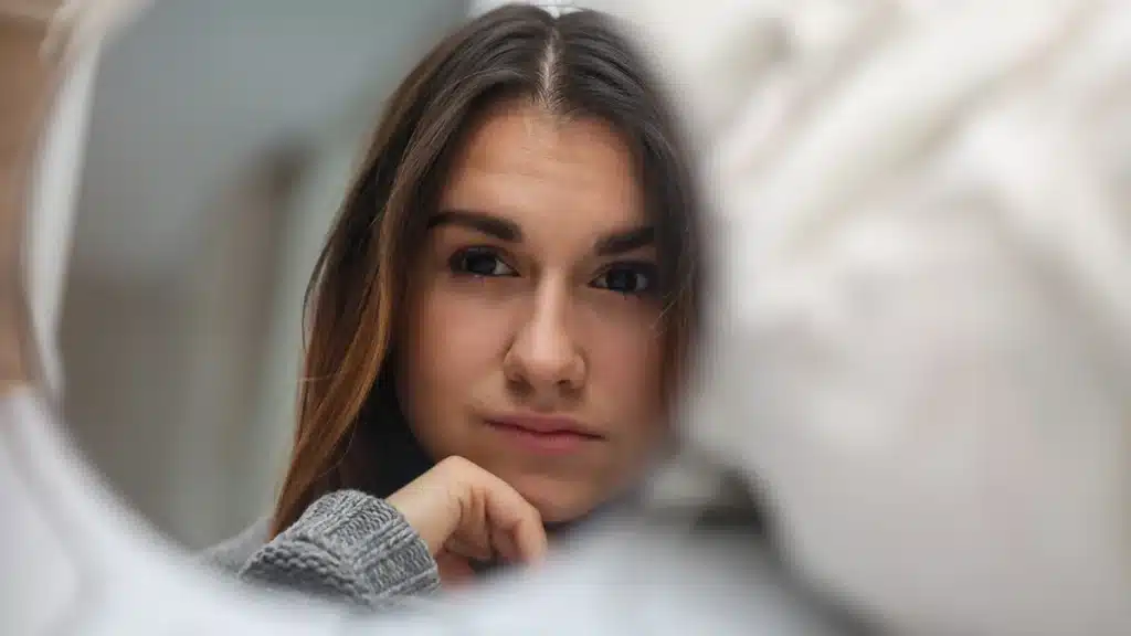 Self-esteem And Addiction: Tackle Teen's Recovery 4 Woman looking at herself in the mirror.