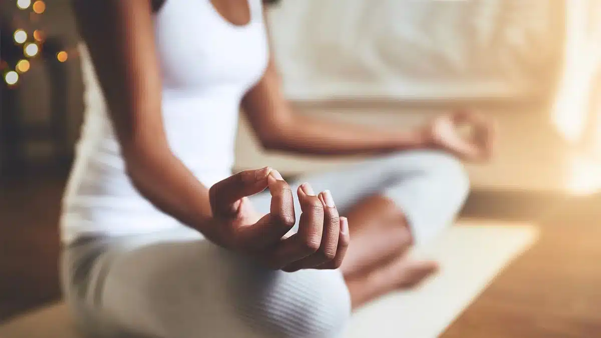 Illustration of a teen in a peaceful yoga pose surrounded by natural elements.