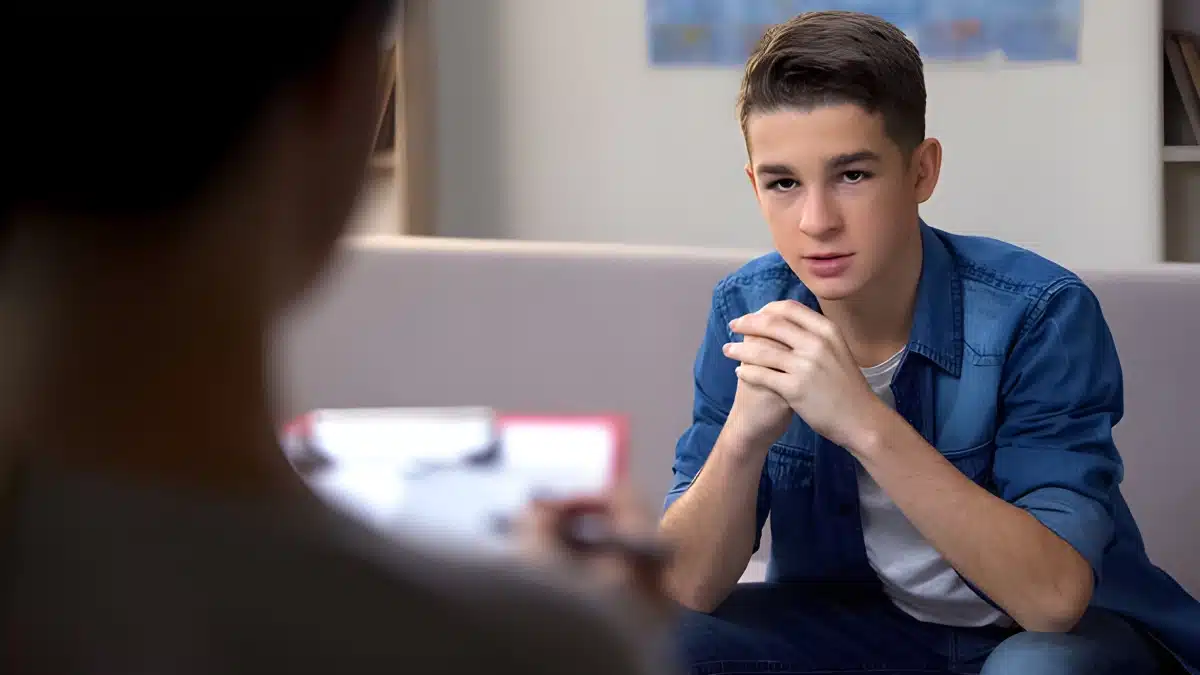 teenager looking at his therapist intently