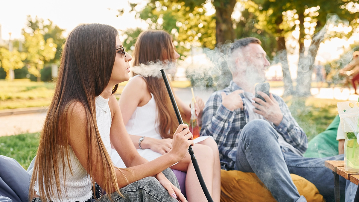 teenagers smoking through a hookah